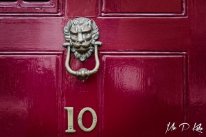 Centaur Head on a red door knocker on a red door