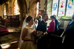 Colour photograph of Bride and Groom march down the aisle