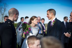 Image of bride giving instructions on calling for participants in formal wedding photographs