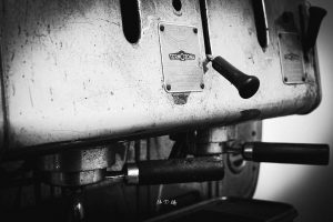 Black and white image of a double group head of a Termozona Tortorelli espresso machine
