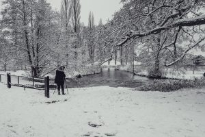 Photographer capturing images of the snowstorm in Blenheim Palace grounds in Woodstock, Oxfordshire